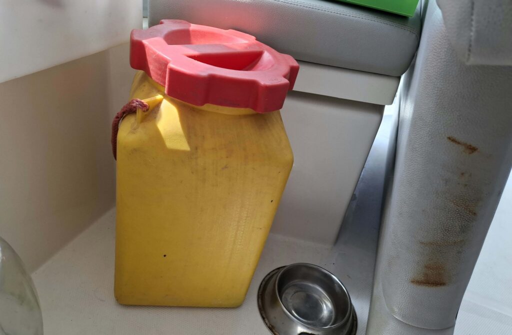 Yellow container with dog food bowl next to it